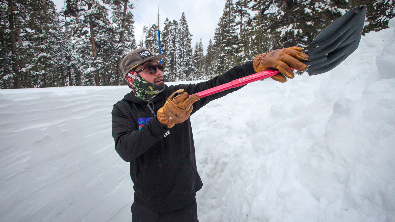 openai a person with raising a snow shovel up at head height