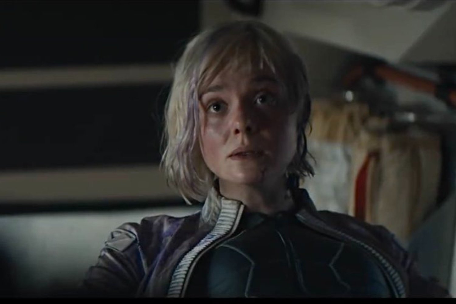 artificial intelligence Elle Fanning sits down and looks at something.