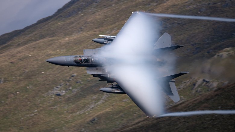 openai An F-15E Strike Eagle low flying over hills